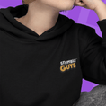 Load image into Gallery viewer, Person wearing a black hoodie with 'Stumble Guys' logo on a purple background