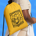 Load image into Gallery viewer, Yellow drawstring bag with 'Champion Stumblers Only' design held by a person against a blue background