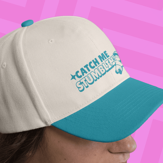 Woman wearing a white hat featuring Mr. Stumble and 'Catch me stumbling' printed text