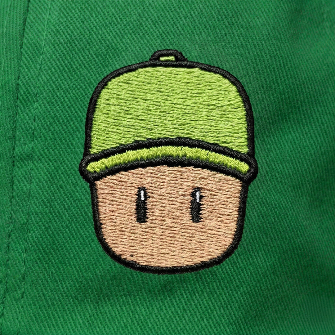 Embroidered Mr. Stumble, in green cap, on a green background.