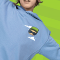 Load image into Gallery viewer, Child wearing blue Mr. Stumble hoodie on a green background
