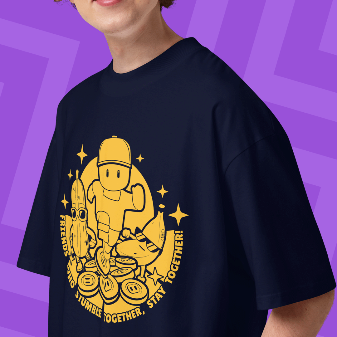 Person wearing a navy blue t-shirt with yellow Stumble Guys graphic design a pink background