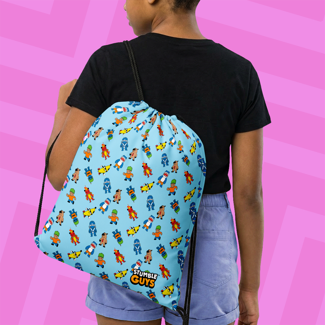 Person wearing a blue drawstring bag with colorful Stumble Guys character pattern on a pink and purple striped background