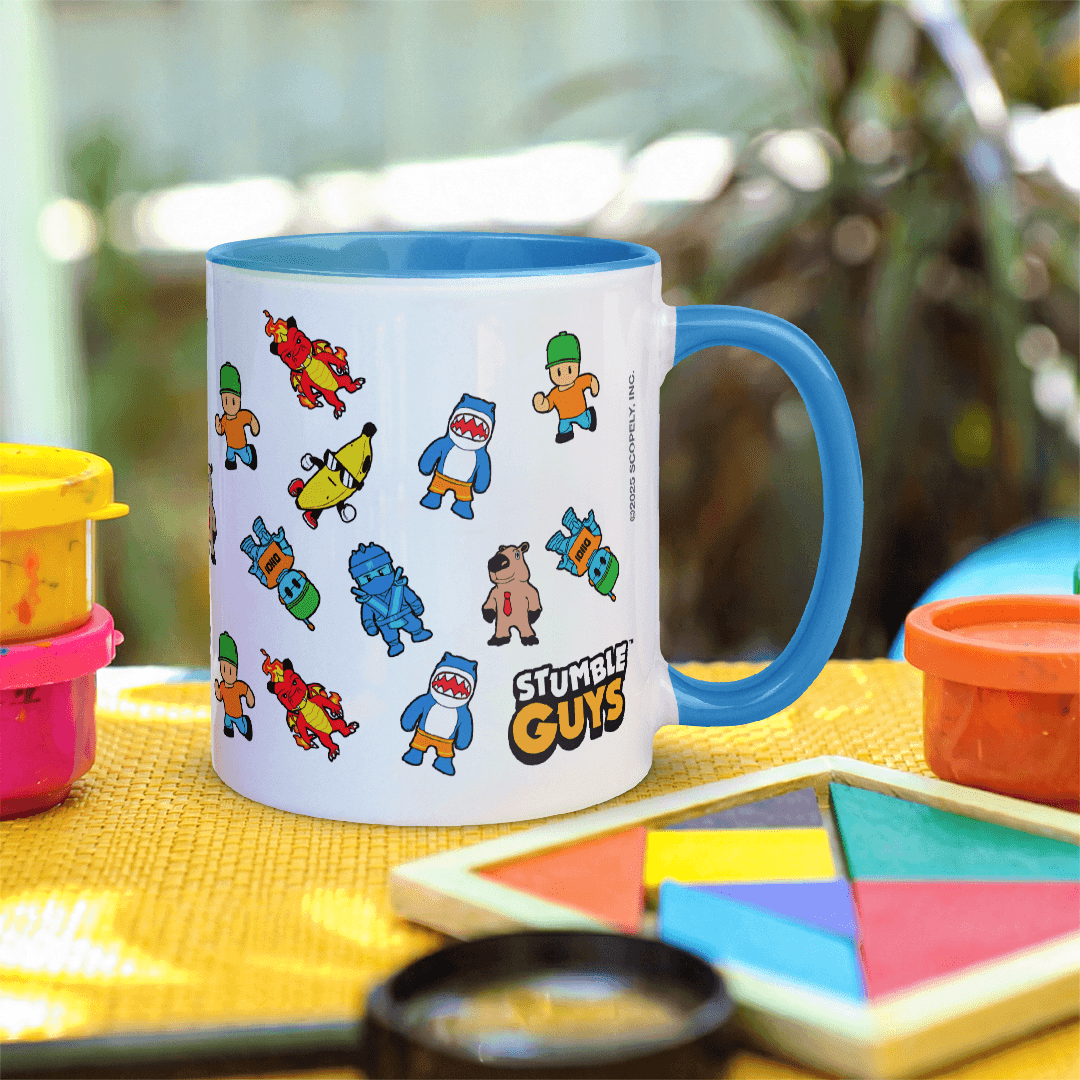 Mug with Stumble Guys character designs on a table with toys