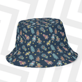 Load image into Gallery viewer, Bucket hat with colorful Stumble Guys pattern on a white chair
