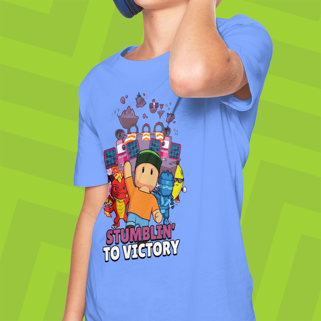 Person wearing a blue t-shirt with Stumble Guys graphics and text on a green background